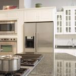 Costa Esmeralda granite reflects beauty in this white kitchen